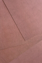 sheets of terracotta brown scrapbook paper layered on one another