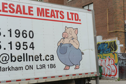 Markham, Ontario meat processing and distributor transport truck (featuring a cartoon pig in overall), spotted in Chinatown, Toronto