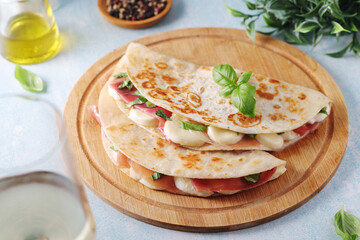 Traditional Italian dish Piadina romagnola - flat bread with mozarella and proscuitto