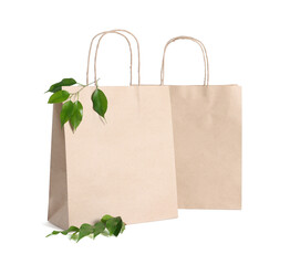 Eco friendly packaging. Paper bags and leaves isolated on white