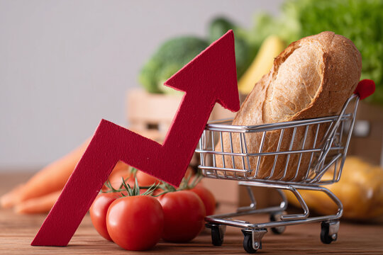A shopping cart full of vegetables and a red arrow pointing upwards