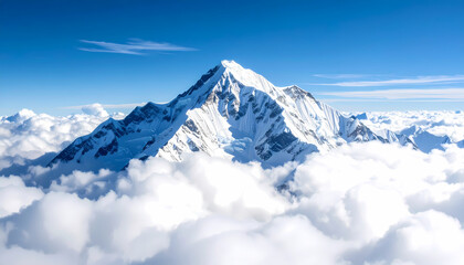 Awe inspiring view of majestic mountain peak with snow covered summit rising high above sea of cloud. beautiful alpine landscape under clear blue sky, symbol of nature