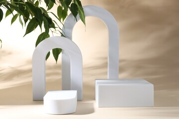 Promotion. Podiums for product presentation and green leaves on beige background