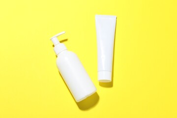 Cosmetic products on yellow background, flat lay. Mockup for design