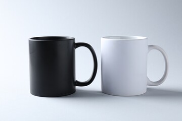 Mugs on light background. Mockup for design