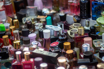 A vibrant collection of assorted perfume bottles and fragrances displayed together