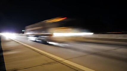 Highway at night with motion blur of passing vehicles, dark sky above, abstract