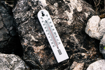 Temperature measurement on rocky surface outdoor setting nature photography close-up view environmental awareness