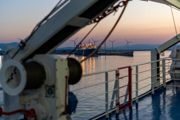 Ship deck view toward sunset harbor