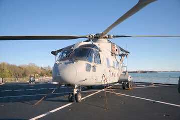 Military helicopter parked on navy ship deck