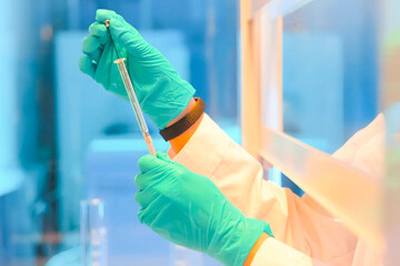 laboratory assistant holds the flask with the test substance in