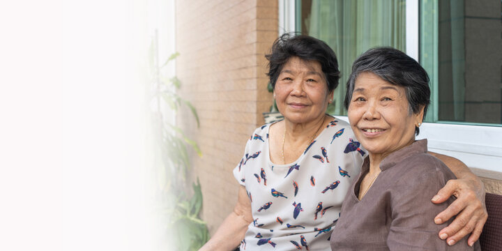 Happy senior friendship society concept. Portrait of Asian female older ageing women smiling with happiness in garden at home, nursing home, or wellbeing county with copyspace