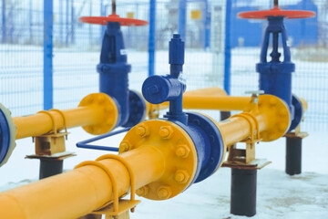 shut off valves on an oil and gas pipeline, painted blue and red.