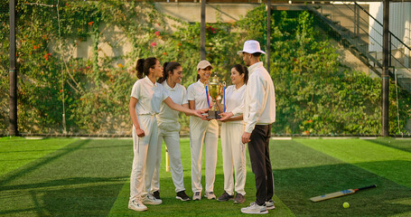 Indian asian young adult gen z sports woman lady group team standing with coach man win cricket match hold trophy do celebrate outdoor male trainer female player cheering have fun joy play ground