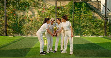 Indian young adult gen z sports woman lady group win match held award in hand enjoy day time happy female team cheering have fun joy at play ground place