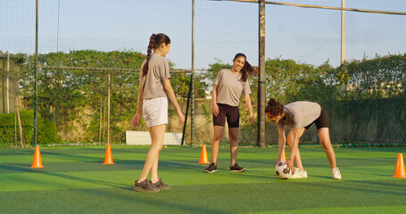 Indian happy young adult gen z group sports woman lady play football learn at outdoor yard female...