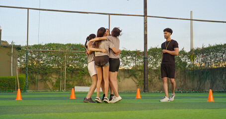 Indian young adult gen z coach man blow whistle sport happy woman lady win casual football match outdoor referee male trainer playful female girl wear uniform learn soccer game outside ground