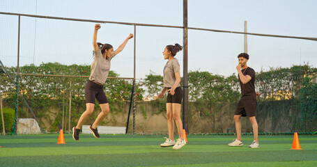 Indian young adult gen z coach man blow whistle sport happy woman lady play casual football outdoor...