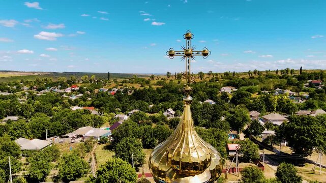 Aerial View of Moldovan Village with Blue and Gold Orthodox Church Surrounded by Lush Greenery