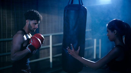 Indian young adult gen z angry fit boxer man guy wear gloves do hand fist boxing punch beat hit on...