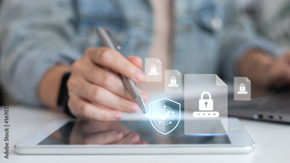 Poster hand using a tablet with a stylus and a hologram lock file icon. concepts of cybersecurity, data pro