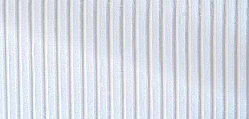Obraz premium Close-up of white ribbed cardboard, showing texture and subtle light reflections, vertical, uneven
