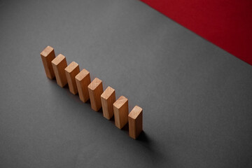 Domino has Fallen in a Row. Domino theory. Effect. Hand with Finger is Pointing and Pushing the...