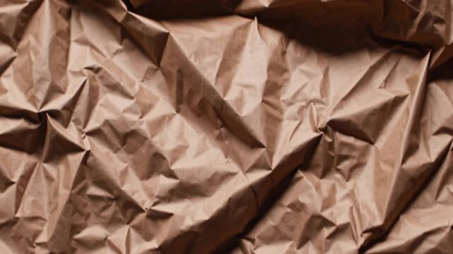 sheet of paper material in brown hue that has been compressed to create textured surface