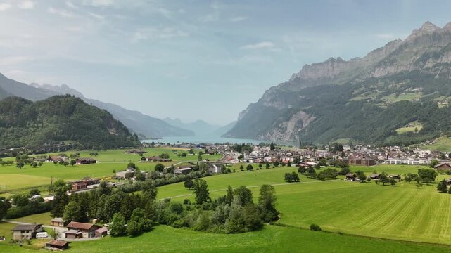 Aerial Drone View of a Scenic Valley with Green Fields and Mountainous Landscape in Switzerland near Flums, Berschis, and Walenstadt in St. Gallen Canton