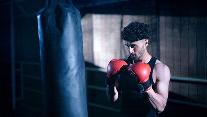 Indian young adult gen z angry fit boxer man guy wear gloves do hand fist boxing punch beat hit on...