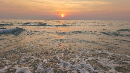 Evening atmosphere by the sea, the orange light of the sunset