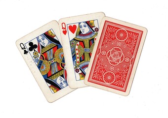 A hand of three vintage playing cards with two cards revealed on a white background.