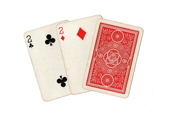 A hand of three vintage playing cards with two cards revealed on a white background.