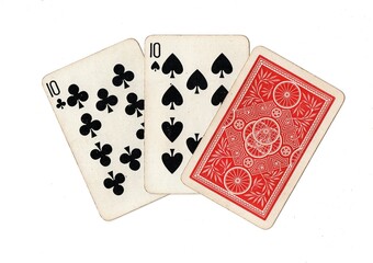 A hand of three vintage playing cards with two cards revealed on a white background.