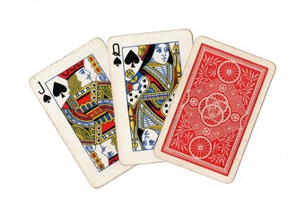A hand of three vintage playing cards with two cards revealed on a white background.
