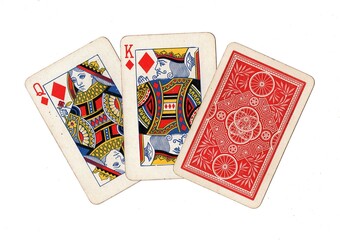 A hand of three vintage playing cards with two cards revealed on a white background.