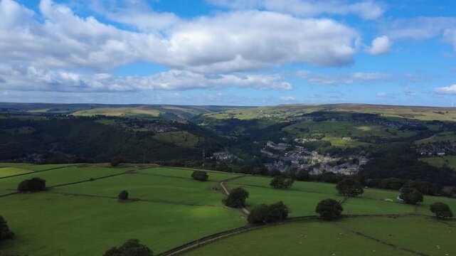 aerial drone view of west yorkshire landscape in calderdale with hebden bridge and heptonstall visible between hills
