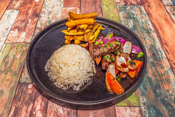 Classic lomo saltado with strips of tender beef tenderloin, wedged onions, plum tomatoes, and fresh cilantro, a blend of flavors that define Creole cuisine