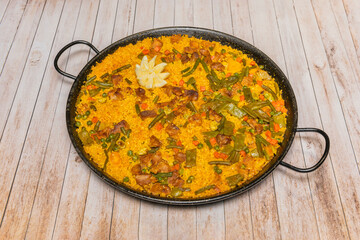 Duck paella with a red wine reduction, showcasing The juicy pieces of meat and the brilliant rice