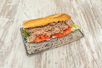 Fresh preserved tuna sandwich with grated natural tomato and hard-boiled egg, served on rustic...