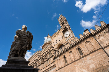 View of one of the four bell towers of Palermo Cathedral, featuring the only tower with a clock. Sicily, Italy