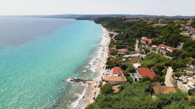 Afytos beach, Athytos, sea and hotels in Kassandra Halkidiki, Greece. Amazing sea with clear blue water. Aerial panoramic drone view from above, top view from drone. Summer holidays Europe
