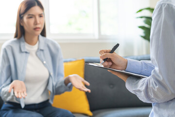 Psychology, depression. Suffer asian young woman consultation with psychologist while patient...
