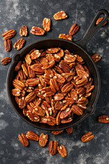 Pecan nuts in a cast iron pan, healthy snack