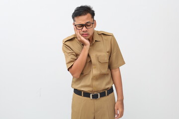 Asian man in civil servant costume having toothache. Isolated on white