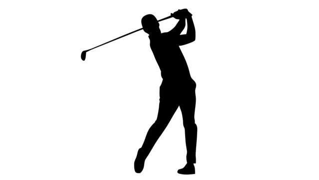Silhouette of a golfer in mid swing with the golf club raised high during the backswing action motion shot
