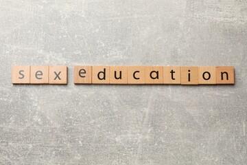 Phrase Sex Education made of wooden letters on grey table, top view