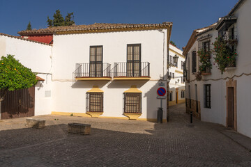 Fototapeta premium Beautiful street in the old town of the city of Ronda at sunset. Malaga, Andalucia, Spain.