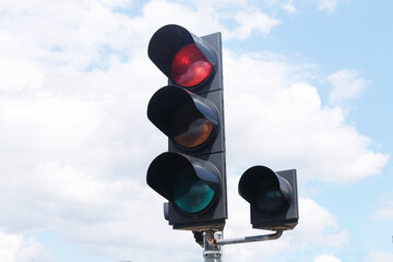 Traffic light with red signal on sky background. Stop sign for cars and vehicles. Road safety and...