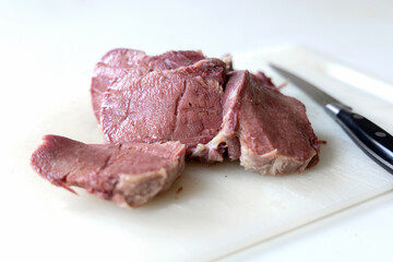 Prepared beef tongue slices on clean board